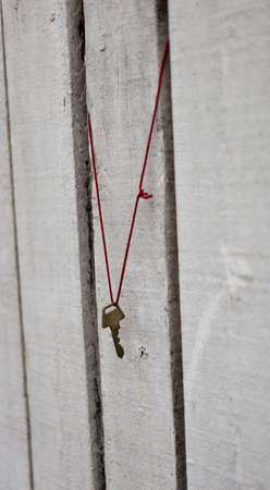 Lost Key Hanging on white painted wood.の写真素材