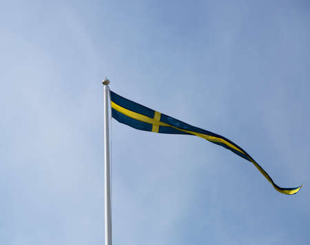Swedish Pennent Waving on Flagpoleの写真素材