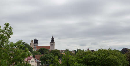 The Visby Church on Gotland in Sweden with a cloudy sky and trees.の写真素材