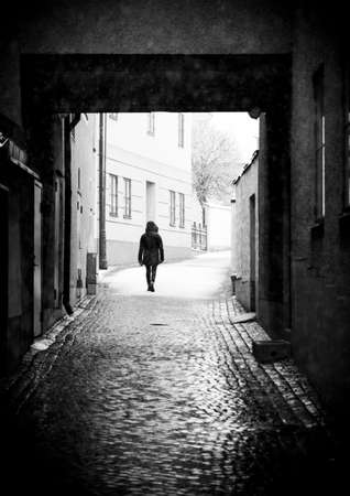 Person Walking in Alley in Visby, Gotlandの写真素材