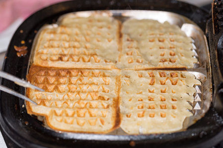 Waffle in Waffle Iron close up.