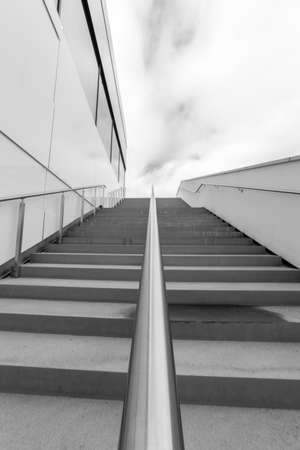Steps with Railing by Building in black and whiteの写真素材