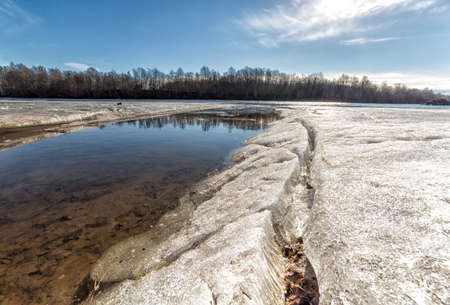 Ice by River in Umea, Sweden with a blue skyの写真素材