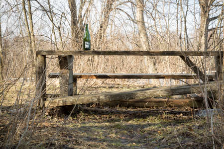 Wine Bottle on Broken Table Outdoorの写真素材