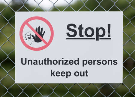 Stop Sign on Wire Fence close up.の写真素材