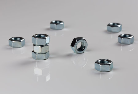 Hardware Nuts Close Up on gray background.