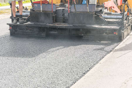 Asphalt Paver Laying Down Asphalt close up.の写真素材