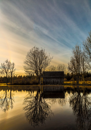 Old Wooden Building by pond.の写真素材