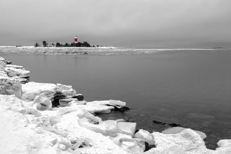 Light House with Icy Ocean and a cloudy sky.の写真素材