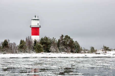 Light House with Icy Ocean and a cloudy sky.の写真素材