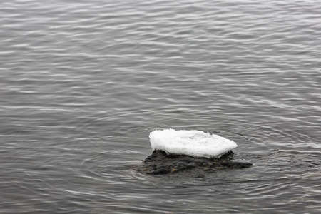 Ice on Top of Rock in Water.の写真素材