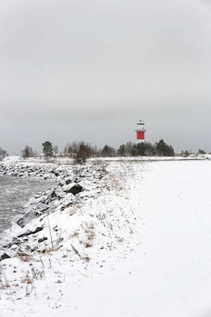 Light House with Icy Ocean and a cloudy sky.の写真素材