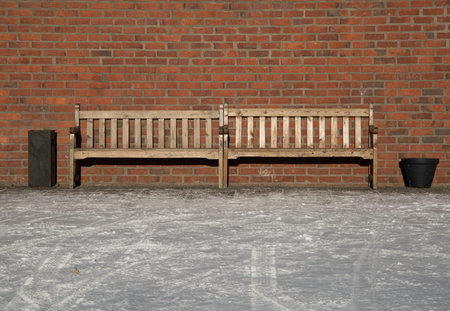 Pair of Benches by brick wall.の写真素材