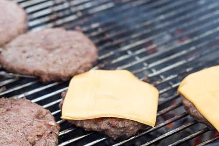 Hamburger Patties on Barbecue with cheese.の写真素材