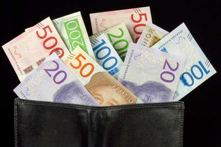 Wallet with Swedish Krona Currency on black background.の写真素材