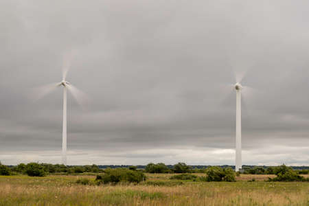 Wind Power Stations Spinning in Green Field.の写真素材