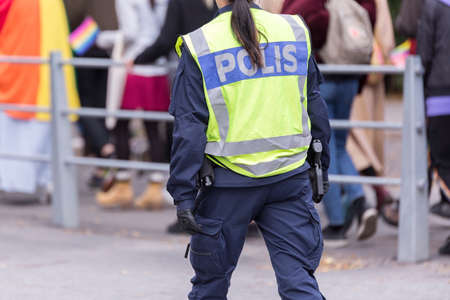 Swedish Police Officer with Reflective Vest and gun.の写真素材