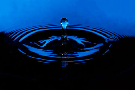 Water Droplet with Ripples blue and black.の写真素材