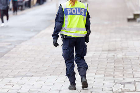 Female Police Officers back with reflective vestの写真素材