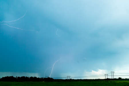 Lightning over Agricultural Field with a cloudy sky.の写真素材