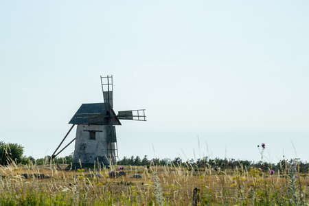 Windmill in Field with Grass and a cloudy sky.の写真素材