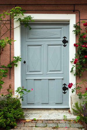 Blue Door with Rose bush .の写真素材
