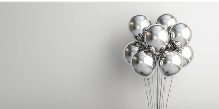 Many beautiful silver holiday balloons on a light white backgroundの素材