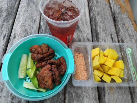 Raspberry Iced Tea with Fish Cake and Pickled Mango.の写真素材