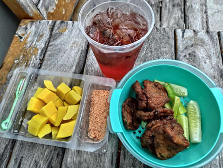 Raspberry Iced Tea with Fish Cake and Pickled Mango.の写真素材