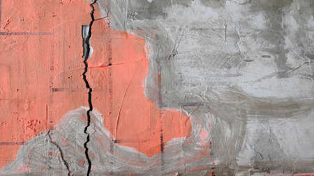 Gray cement concrete wall pattern with cracks on the surface as backgroundの写真素材