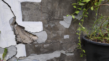 Gray cement concrete wall pattern with cracks on the surface as background.