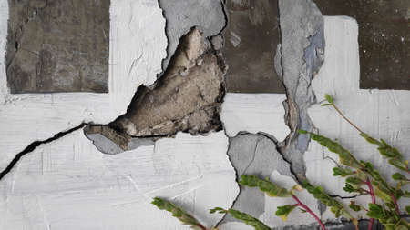 Gray cement concrete wall pattern with cracks on the surface as background.の写真素材