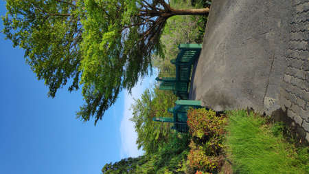 A small green wooden bridge over the canal in the park Bangkok, Thailand.の写真素材