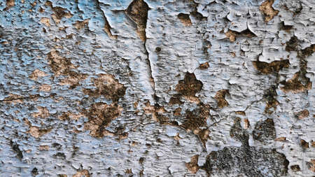 Stock Photo - The old flaky blue paint peels off the old cement plaster wall.の写真素材