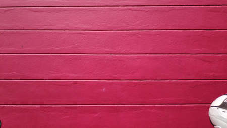 Stock Photo - Old building with red and pink background on cement wall surface.の写真素材