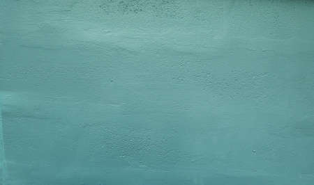 Stock Photo - Textured cement plaster or turquoise concrete wall is used as a background.の写真素材
