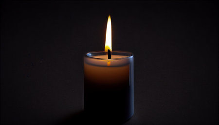 Candle Light Power dark background. Isolated burning candle flame fire light composition in the dark background.の素材