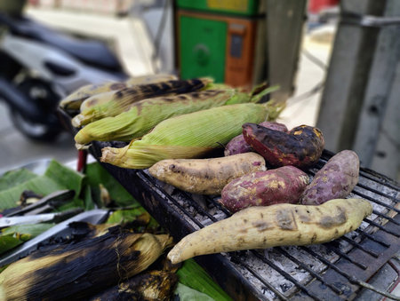 Corn,banana and sweet potato grilled traditional,sidewalk food vendors,street food stall,street vendor in Bangkok - Stock Photoの素材