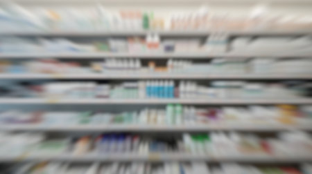 Blurred image of a pharmacy aisle with shelves full of medicines.の素材