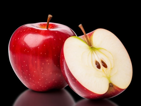 Red apples with one cut in half and one isolated on black background,clipping path included for easy isolation.の素材