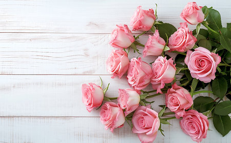 Pink roses on white wooden background,flat lay, top view with copy space for your text or product display.World Rose Day Concept.の素材