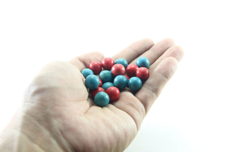 blue and red beads on the left handの写真素材