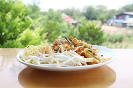 Iced drink honey lemon soda refreshment juice in the glass put on wood table and green tree backgroundの写真素材