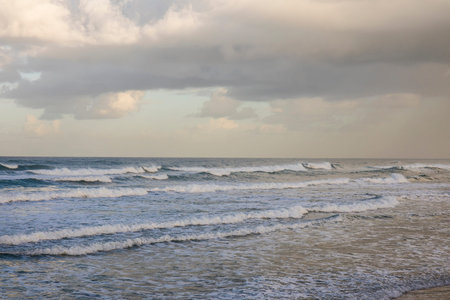 A wavy sea under a cloudy winter skyの写真素材