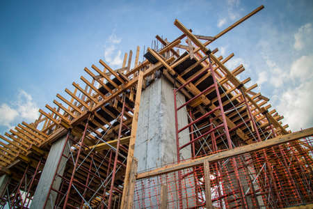 A building in the first stages of construction, with scaffolding around it.の写真素材