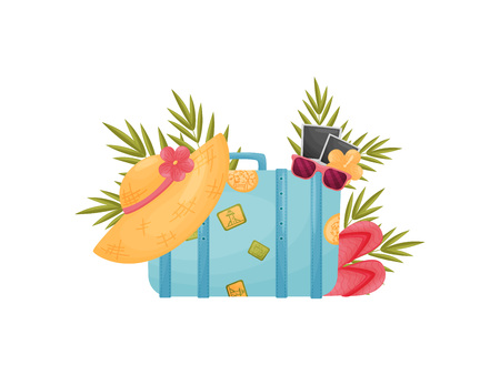 Old-fashioned closed blue suitcase with stickers and attributes for travel. Straw hat, sunglasses, flower, photo card. Vector illustration on white background.のイラスト素材