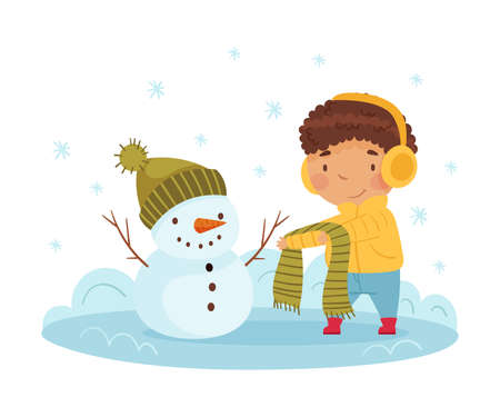 Happy Boy in Earmuffs Building Snowman and Dressing Him Up in Scarf and Hat Enjoying Winter Vector Illustrationのイラスト素材