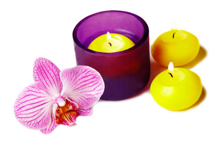 Orchide flower and candles on white backgroundの写真素材