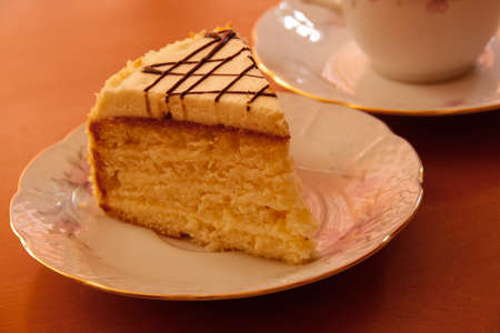 sweet cake with cup of tea on wooden backgroundの写真素材