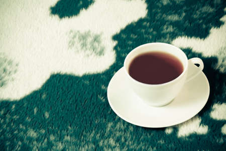 White cup of tea on the  white-blue blanketの写真素材